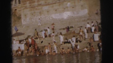 1962: people bathing in the river as a boat passes by BANGKOK, THAILAND