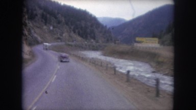 1962: Car Driving Through Colorado Mountains