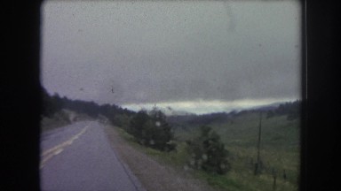 1962: a highway between a forest area is seen in a hilly area COLORADO