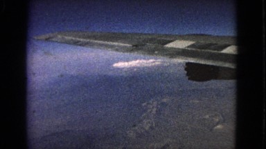 1963: looking out of a plane window while flying over some mountains BARRINGTON,