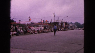 1963: two men in the center of the street with a large crowd gathered
