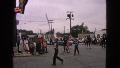 1963: small town parade featuring people skiing and with water slide float