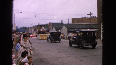 1963: man performs several backflips on trampoline float in parade