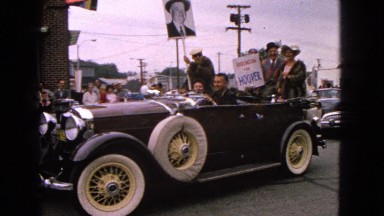 1963: small town corner parade to celebrate president hoover featuring cars