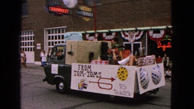 1963: a makeshift chariot moves pompous and garishly in a popular festival