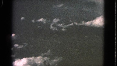 1963: the scene shows an aerial view of beautiful mountains and high grasslands