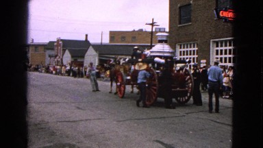 1963: Crowd Gathered on the Side of the Street to Watch a Horse Drawn Cart
