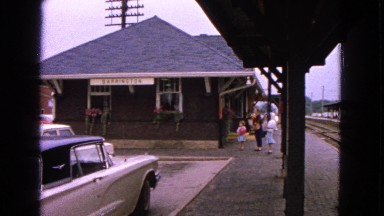 1963: family with children playing with balloons on sunny day waiting at the