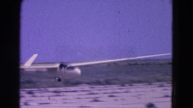 1964: white aircraft safely landing on runway in the desert ELMIRA, NEW YORK
