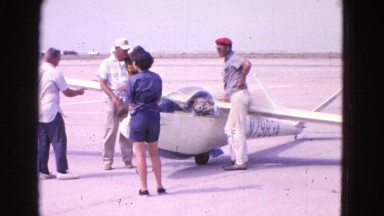 1964: a group standing in front of a small airplane and then the airplane