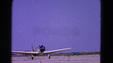 1964: various small airplanes, including a single propeller plane, taking off
