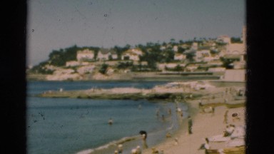 1948: Seaside Resort in Portugal with Beachgoers and Cabanas