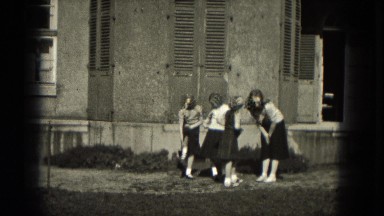 1953: older cheerleader teaching new recruits the ropes outside..MILWAUKEE,