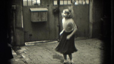 1953: Two ooxforded little girls jumping rope, running in and out while rope