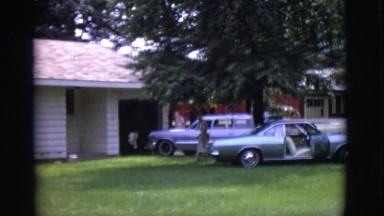 1966: Woman waving to the camera before she walks into the house..CLARKDALE,