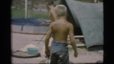 1968: Two Young Boys Boiling Water Over a Campfire in Cottonwood, Arizona
