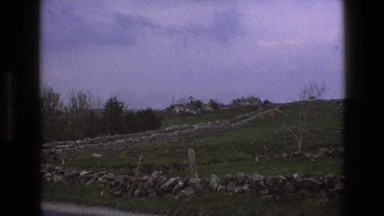 1969: winding road up the side of the hill with a stone fence lining either side