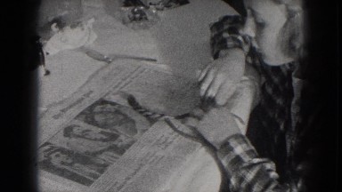 1953: Two Young Girls Braiding Hair and Laughing Indoors in Milwaukee