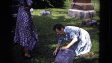 1953: a person is seen fixing a grave board MILWAUKEE, WISCONSIN
