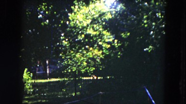 1953: house in the woods, kids playing, and a man walking around and waving