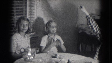 1953: three pretty young girls having a tea party with treats and playing around