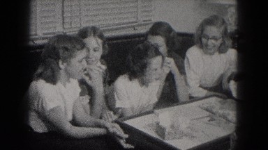 1953: these girls are having a blast trying to figure out what they have here.