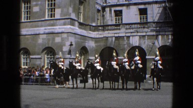 1969: men on horses wait in front of crowd while officer of the law passes