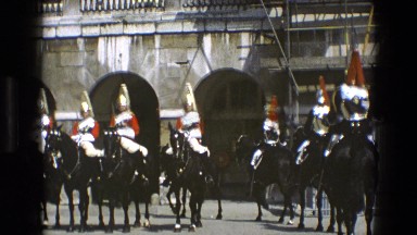1969: men in period military uniforms lining up in formation while riding horses
