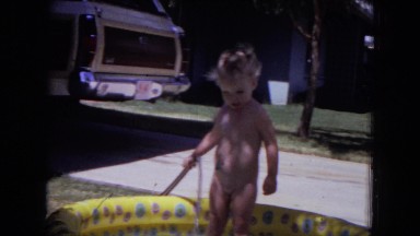 1970: a naked child is seen in a mini pool WHITE SANDS, FLORIDA