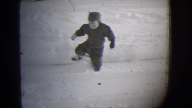 1944: a child is seen walking slowly in snow MICHIGAN