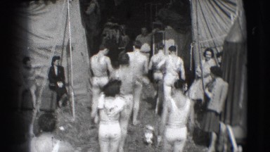 1948: men are seen returning after their act and a lady runs holding her dress