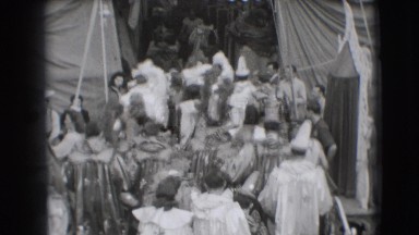 1948: many in costumes seem preparing to enter the circus tent about to begin