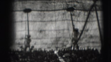 1948: two female circus acrobats in white costumes climb down from the top