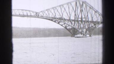 1952: a boat is seen passing by a bridge EDINBOURGH, SCOTLAND