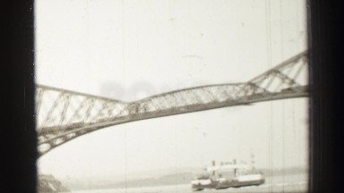 1952: ferry crossing under an iron bridge EDINBOURGH, SCOTLAND