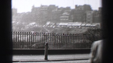 1952: a city is seen with tall buildings along a coastal area EDINBOURGH