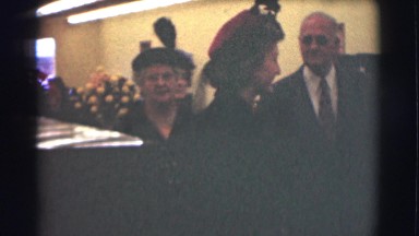 1959: people in a formal meeting with many flowers and dark suits ST. LOUIS