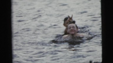 1961: a group of people swimming, splashing and playing in the water CAMDEN