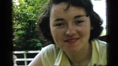 1961: A Beautiful Young Woman in a Yellow Dress Talking in a Rural Area