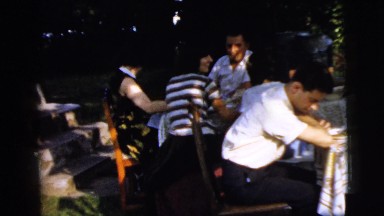 1961: a lively family meal in a country setting with many trees CAMDEN