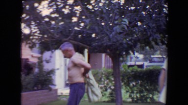 1961: man passes boy while putting on shirt and entering house TOLEDO, OHIO