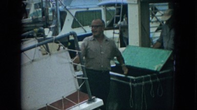 1967: men unpacking fish from their boat at the harbor FLORIDA