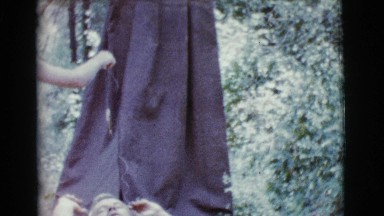 1968: boy feeding man a fish outside in forest COTTONWOOD, ARIZONA