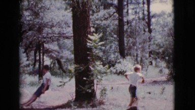 1968: two little boys playing outside in the woods. COTTONWOOD, ARIZONA