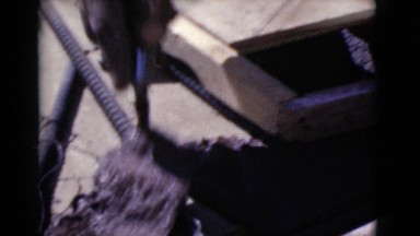 1968: A Man Applying Cement While Building a Brick Chimney in Cottonwood, Arizona