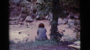 1968: lady sitting by a creek kids making a swing COTTONWOOD, ARIZONA