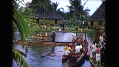 1968: a male and female in a boat on the water performing a dance for a crown
