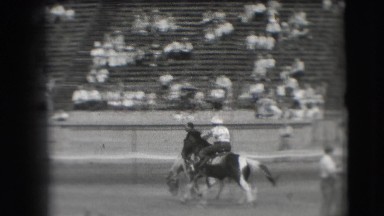 1941: Sparsely Packed Rodeo with Cowboys Riding Bucking Broncos in California
