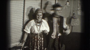 1941: silly-dressed couple poses by window NEW YORK