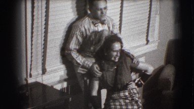 1941: a man and woman posing and smiling playfully in a small room NEW YORK